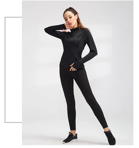Detailed view of women's black long sleeve sports top with thumb holes and mock neck