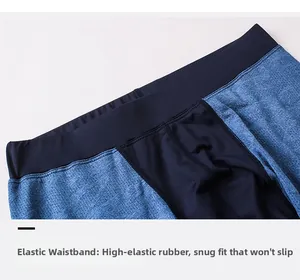 Detail of wide elastic waistband on blue breathable mesh compression pants for men