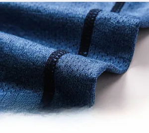 Macro shot of breathable blue mesh fabric with ergonomic flatlock seams for men's sports leggings