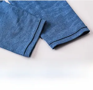 Detail of blue compression leggings showing breathable honeycomb mesh fabric and durable hem