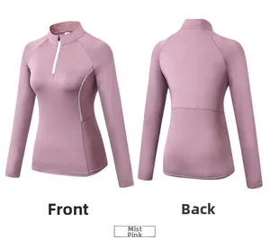 Misty pink athletic top featuring a high-neck half-zip design and reflective side stripes