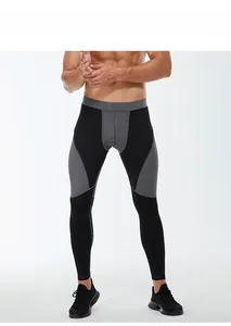 Detail view of men's compression pants with high elastic waistband and snug fitness fit