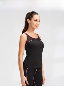 Detail of black yoga tank top featuring pink trim and breathable mesh panels