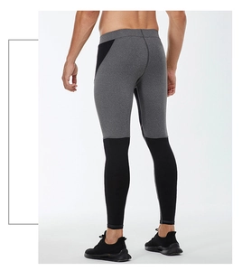 Detailed back view of men's compression leggings with grey and black patchwork stitching