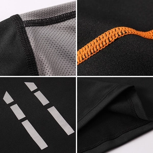 Detail of black sports shirt with breathable mesh, orange flatlock seams and reflective strips