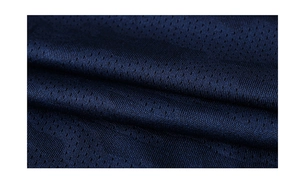 Macro shot of dark blue breathable mesh fabric detail for men's athletic sport shirts