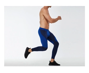 Dynamic side view of men's compression leggings showing blue patchwork and elastic fabric