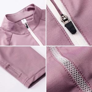 Detail of stand-up collar, white zipper, and thumbhole cuffs on purple yoga jacket