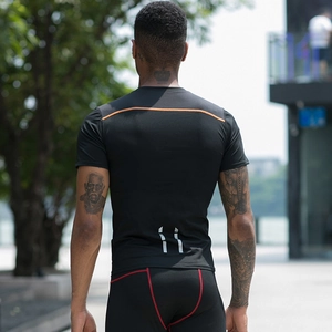 Men's compression workout set featuring reflective stripes and quick-dry black fabric