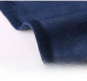 Detail of flatlock seams and breathable dark blue mesh fabric on men's athletic shirt