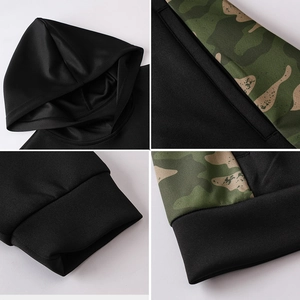 Men's black workout hoodie with green camouflage patchwork and ribbed cuffs details