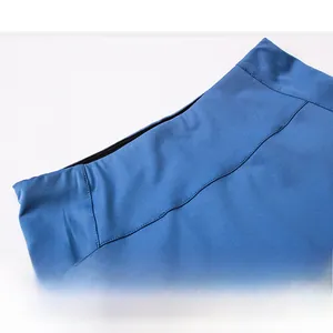 Detail of high-waisted blue athletic skirt showing reinforced stitching and elastic fabric
