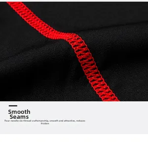 Close-up of flatlock seams with red stitching on black quick-dry sports leggings