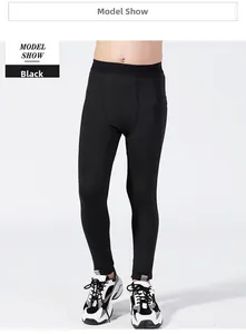 Detail of boys' black compression leggings featuring wide elastic waistband and ergonomic fit