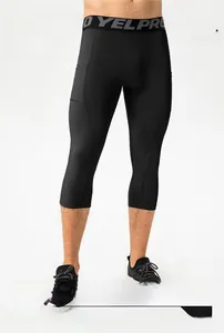 Detail of high-elastic men's compression tights with waist logo and dry-fit fabric texture