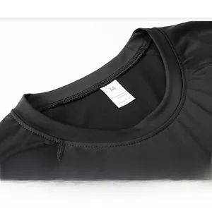 Detail of the crew neck and durable seams on a men's black compression gym shirt