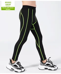 Detail of boys' black compression leggings with neon green stitching and elastic waistband