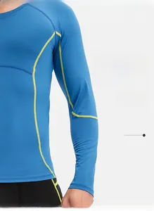 Detail of light blue compression shirt with yellow stitching and ergonomic seams