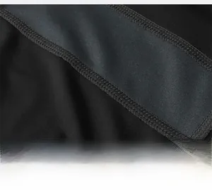 Detailed close-up of smooth flat-lock seams on black high-stretch compression fitness pants