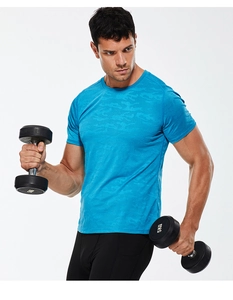 Close-up of moisture-wicking blue camouflage athletic fabric during dumbbell workout