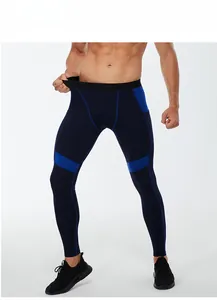 Detail view of men's compression pants with blue color blocking and elastic side pocket