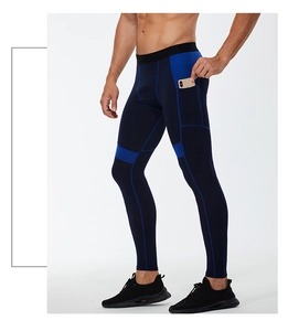 Detail of ergonomic side pocket on navy blue compression pants for phone storage