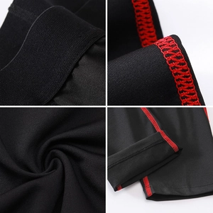 Detail of boys athletic compression pants with durable red flatlock stitching and elastic waistband