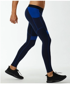 Detail of blue compression pants with side pocket and reinforced stitching for men