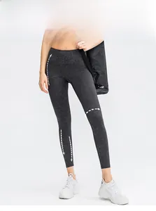 Detailed view of high-waist yoga leggings featuring a dark marble pattern and seamless design
