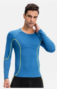 Blue compression shirt detail featuring yellow contrast stitching and ergonomic flatlock seams