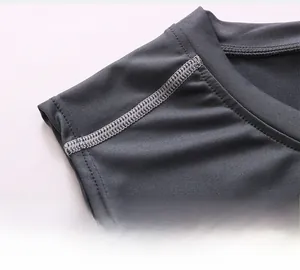 Close-up of seamless stitching and breathable dark grey fabric on men's sports vest