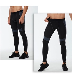 Detail view of men's compression pants with grey patchwork and high elasticity fabric
