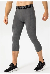 Close-up of men's gray compression capri pants with logo waistband and side phone pocket