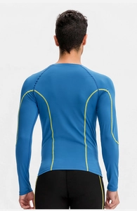 Detail of high-stretch compression shirt with contrast neon stitching and raglan sleeves