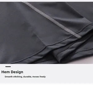 Close-up of dual-needle hem stitching on dark grey moisture-wicking men's sports vest