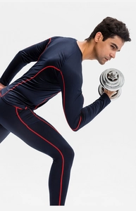 Detail of navy blue men's compression sports set with red contrast stitching and high elasticity