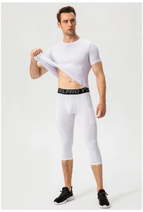 Detail of men's white compression leggings with elastic waistband and high-stretch fabric