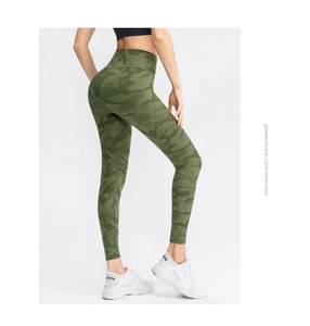 Detail view of high waist olive camo yoga pants showing seamless fit and sleek leg lines