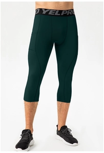 Close-up of green compression sports shorts with elastic waistband and phone pocket
