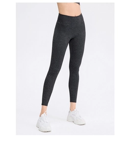 Close-up of high-waist women's yoga leggings with black irregular dark patterns and textures