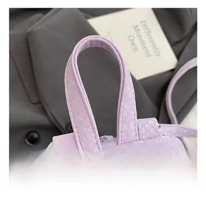 Close-up of lilac purple faux leather handle with snakeskin texture and neat stitching