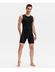 Front view of men's black compression sports set with gray stitching and muscle contouring