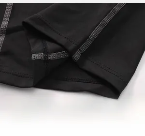 Détail des coutures plates sur un short de compression noir pour entraînement homme