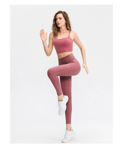 Détail du legging de yoga taille haute avec poche latérale rose poudré et haut assorti