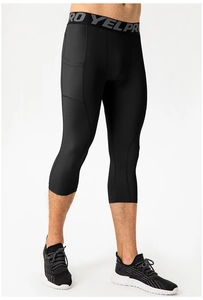 Detail of men's black compression capris with wide elastic waistband and side pocket