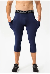 Detail view of men's navy blue compression capris featuring functional side pockets