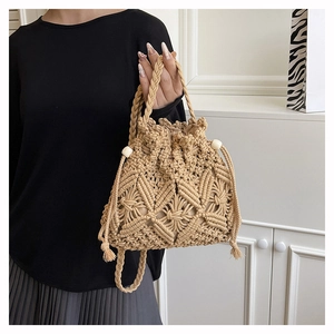 Close-up of beige crochet bucket bag featuring hollow diamond patterns and wooden beads