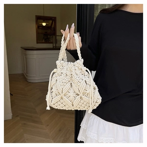 Detailed macro view of the intricate hand-knitted cotton bucket bag with diamond patterns