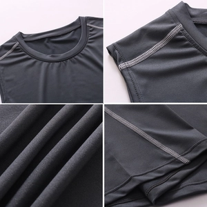 Detail of gray athletic vest showing crew neck and high-density four-needle six-thread stitching