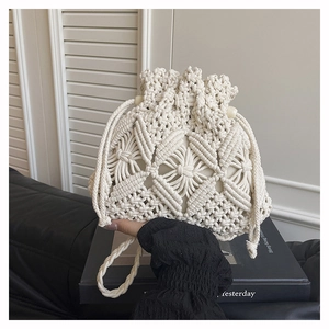 Close-up of macramé woven bucket bag with diamond hollow patterns and wooden beads